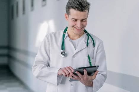 cheerful-young-doctor-using-tablet.jpg